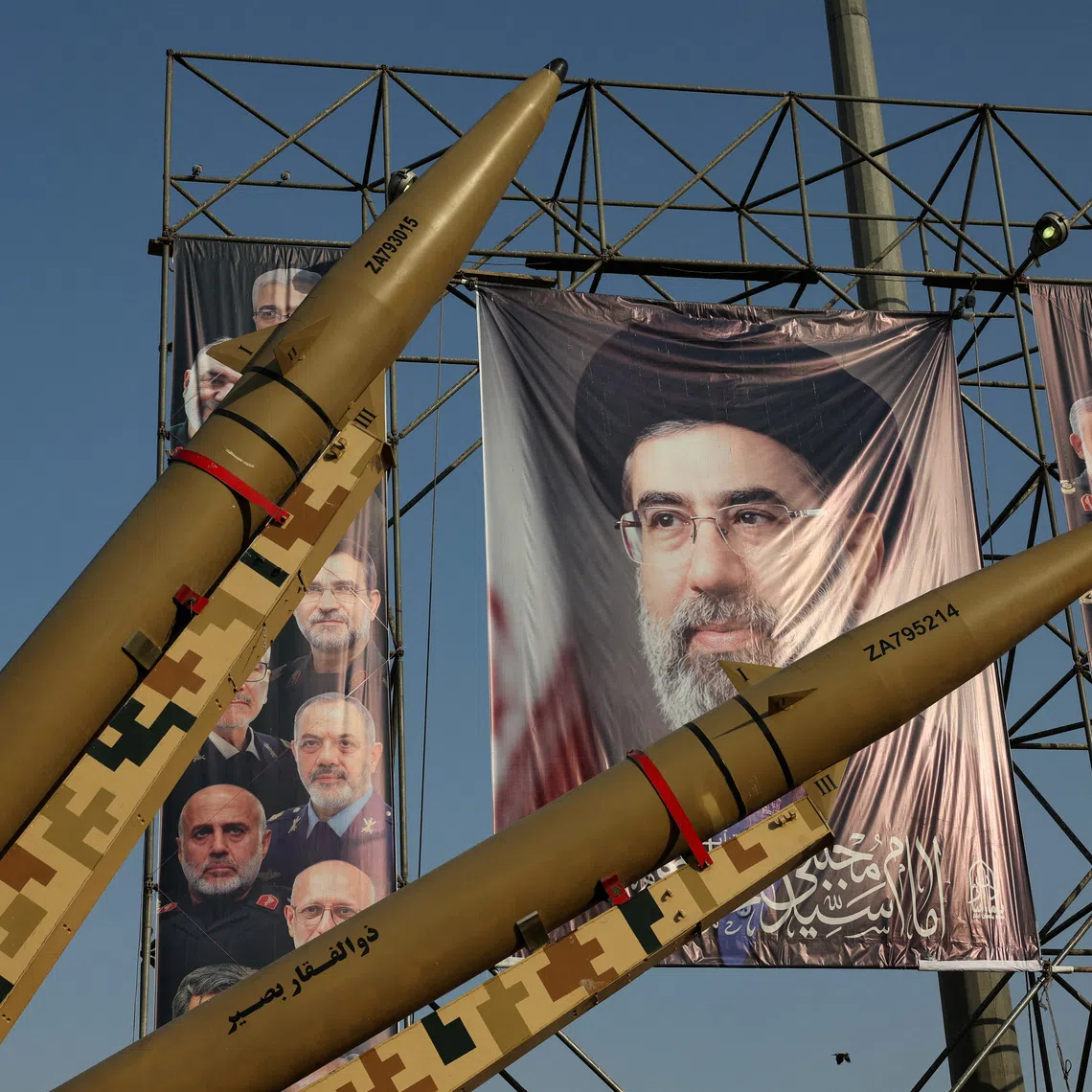 Iranian missiles are displayed next to a banner with a picture of Iran’s Supreme Leader Mojtaba Khamenei, on a street in Tehran, on Sept 27.