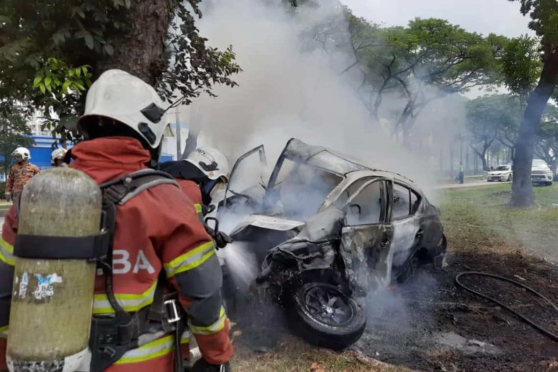 The car crashed into a tree on the side of the road and burst into flames, trapping its driver.