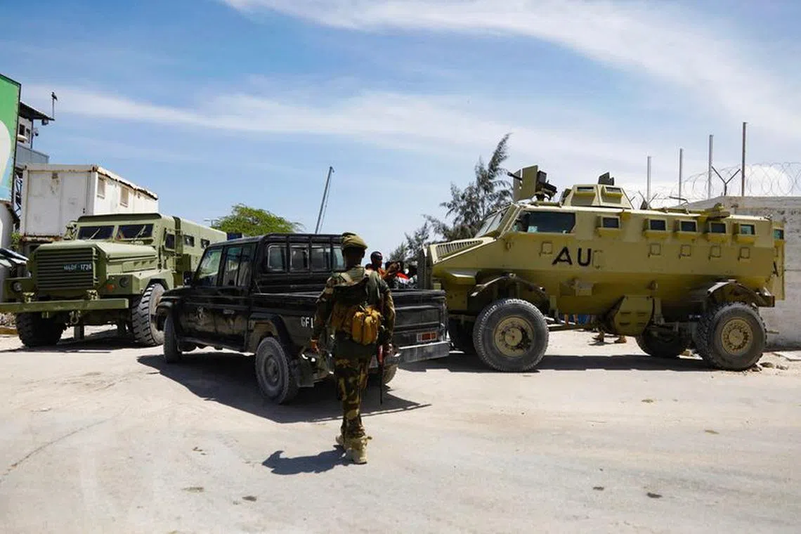 FILE PHOTO: African Union peacekeepers stand next to armoured personnel carriers (APC) as they provide security for members of the Lower House of Parliament who are meeting to elect a speaker, at the Aden Adde International Airport in Mogadishu, Somalia, April 27, 2022. REUTERS/Feisal Omar/File Photo