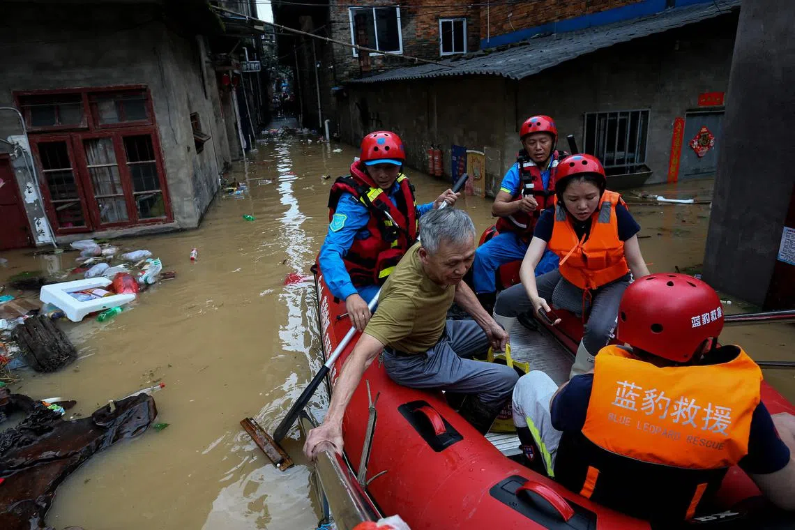 Rescuers evacuate a villager from a flooded district in eastern China’s Fujian province.