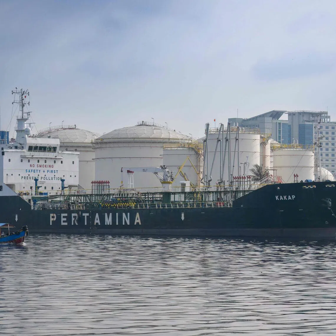 A ship bearing the logo of state-owned oil company Pertamina is anchored at a port near an oil depot in Tanjung Priok Port, Jakarta, on March 31, 2026. 