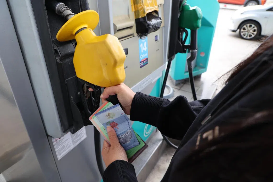 CMG20240817-HengYY02 / 王彦燕 /  A Petronas petrol station in Johor Bahru . For stories about Shell,Petronas, fuel, petrol, station, car, vehicle, transport, oil, energy, petrochemical, tax, Malaysia, Singaporean, 3/4 tank, pump, V Power, 95, 98, Diesel, price setting, price fixing, subsidy. [ Jalan Lingkaran Dalam, Bukit Senyum, 80300 Johor Bahru, Johor, Malaysia]