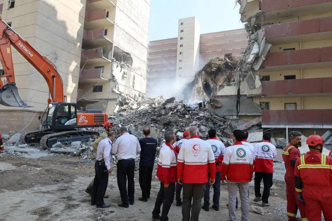 Rescuers work at the site of a damaged building, in the aftermath of Israeli strikes, in Tehran, Iran, June 13, 2025. Iranian Red Crescent Society/WANA (West Asia News Agency)/Handout via REUTERS ATTENTION EDITORS - THIS PICTURE WAS PROVIDED BY A THIRD PARTY. 