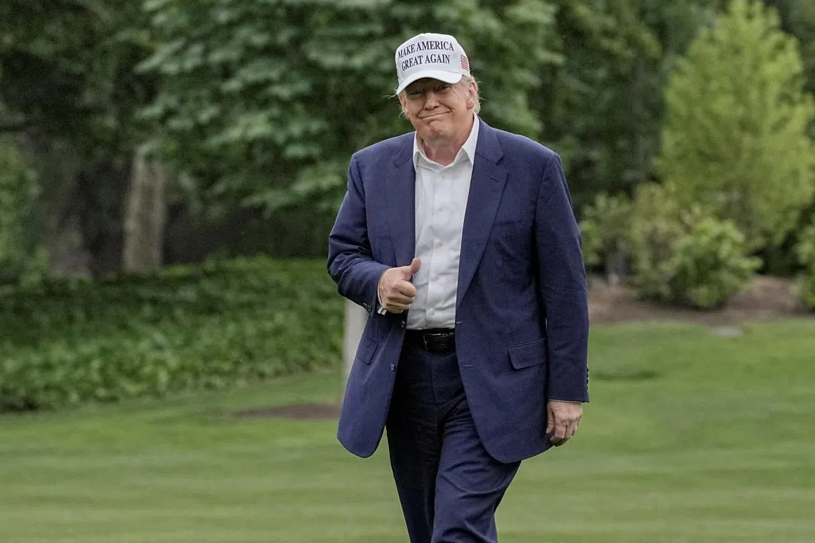 FILE PHOTO: U.S. President Donald Trump gives a thumbs up as he walks on the South Lawn of the White House in Washington, D.C., U.S., May 25, 2025. REUTERS/Ken Cedeno/File Photo