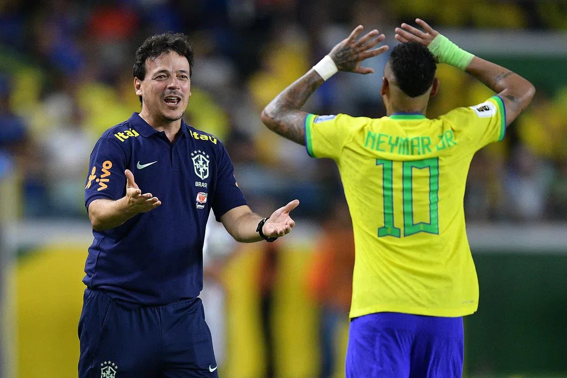 Brazil forward Neymar celebrating with his coach Fernando Diniz after scoring a goal during their World Cup qualifying win over Bolivia on Sept 8.