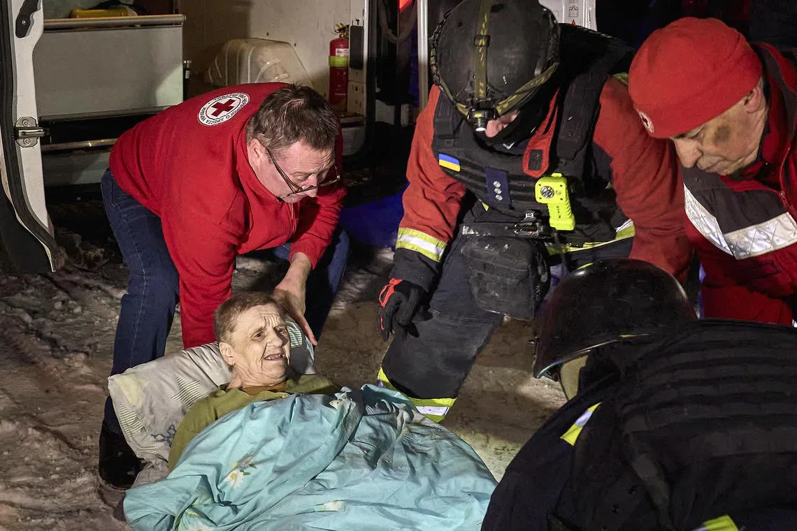 Ukrainian rescuers evacuate patients from a damaged clinic following a drone attack in Kharkiv, Ukraine.