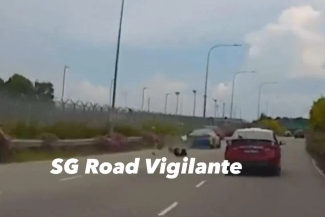 In a video posted on Facebook, a blue taxi is seen straddling the two leftmost lanes of the expressway before it knocked into the motorcycle.