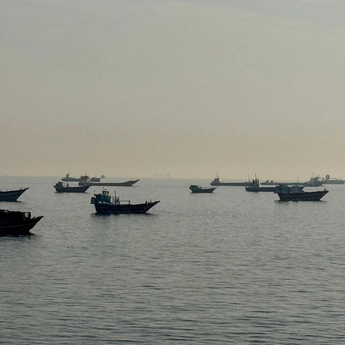 Vessels are seen anchored in the Strait of Hormuz off the port city of Khasab in northern Oman.
