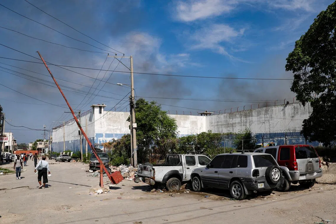 Smoke billows out from the National Penitentiary following a fire, as a powerful gang leader in Haiti has issued a threatening message aimed at political leaders who would take part in a still unformed transition council for the country, in Port-au-Prince, Haiti, March 14, 2024. REUTERS/Ralph Tedy Erol