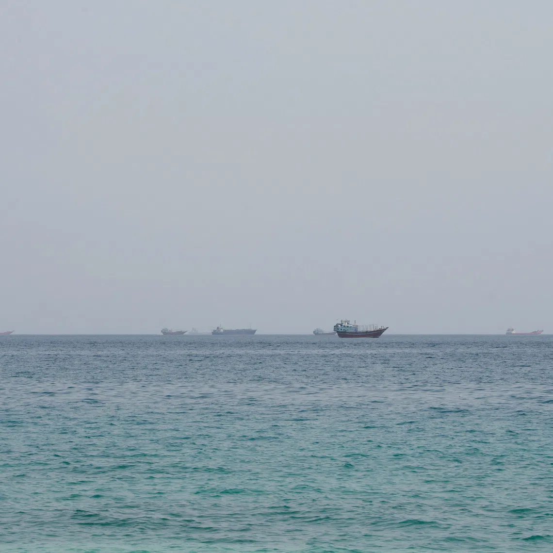 FILE PHOTO: Vessels near the Strait of Hormuz, as seen from Musandam, Oman, August 10, 2026. REUTERS/Stringer/File Photo