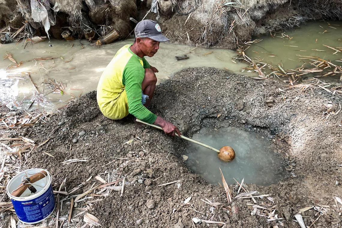 Tobacco farmer Sunardi's village has been digging up the river bed since June, when the water in their wells ran out.