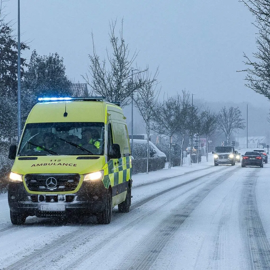 An ambulance on a snow covered street in Nazareth-De Pinte, near De Pinte in Belgium on Jan 7. Europe is reeling from the most bitter cold snap of the winter so far.