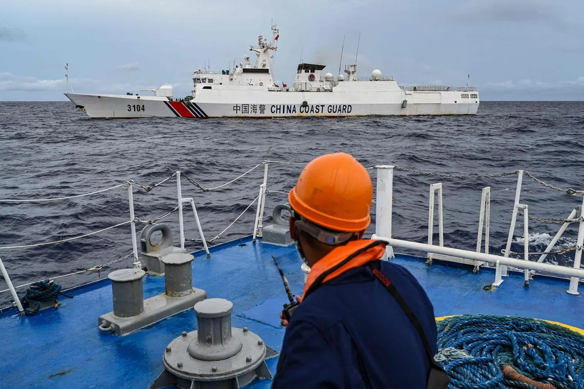 A China Coast Guard ship is seen from a Philippine Coast Guard vessel during a supply mission to Sabina Shoal on Aug 26.