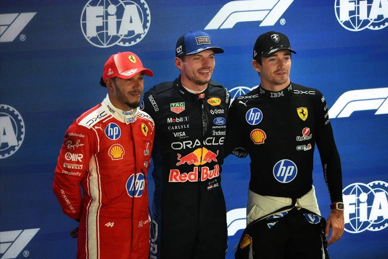 Red Bull’s Max Verstappen (centre) celebrating pole position with Ferrari’s second- and third-placed drivers Charles Leclerc (right) and Lewis Hamilton.