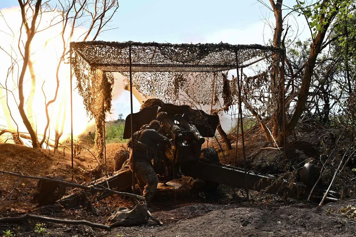 A Ukrainian artilleryman fires a howitzer towards Russian positions on the front line near Bakhmut, in eastern Ukraine.