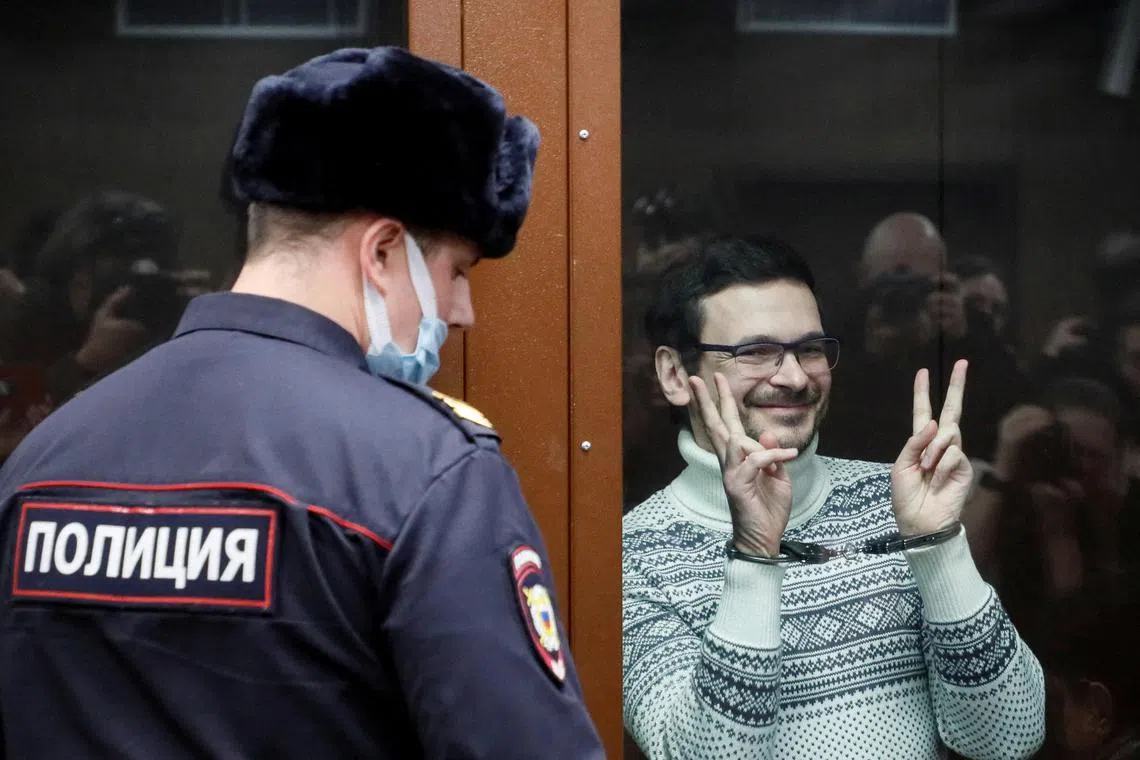 Russian opposition leader, former Moscow's municipal deputy Ilya Yashin gestures in a defendants' glass cage prior to a verdict hearing at the Meshchansky district court in Moscow, Russia, December 9, 2022. Yuri Kochetkov/Pool via REUTERS/File Photo
