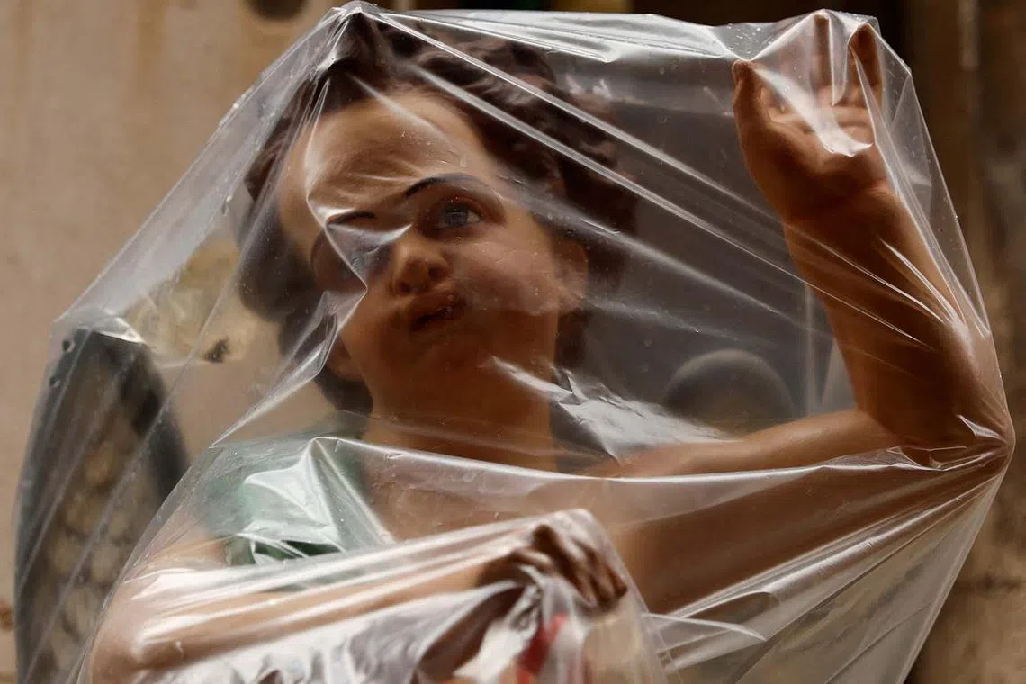 A plastic sheet covering the statue of an angel to protect it from the rain during the feast marking the shipwreck of Saint Paul, Malta's patron saint, in Valletta, Malta, Feb 10, 2025. 