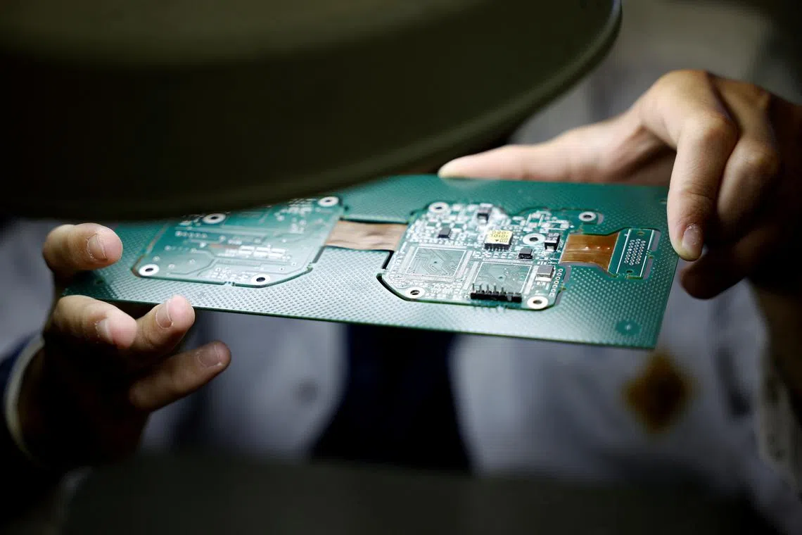 An employee inspects a panel of printed circuit boards (PCBs) at the Hellenic Aerospace Industry (HAI), in Tanagra, north of Athens, Greece, July 3, 2025. REUTERS/Louiza Vradi