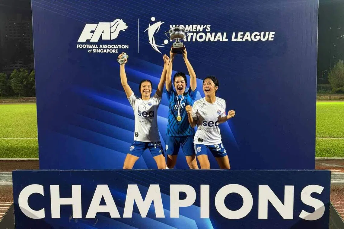 lion city sailors women’s football players celebrate with a trophy after winning a championship