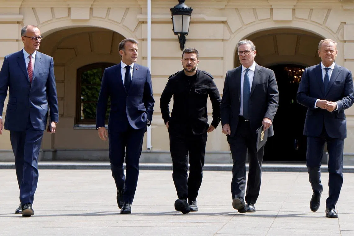 FILE PHOTO: German Chancellor Friedrich Merz, French President Emmanuel Macron, Ukranian President Voloydmyr Zelensky, British Prime Minister Keir Starmer and Polish Prime Minister Donald Tusk walk in the grounds of the Mariynsky Palace, in Kyiv, Ukraine, May 10, 2025. Ludovic Marin/Pool via REUTERS/File Photo