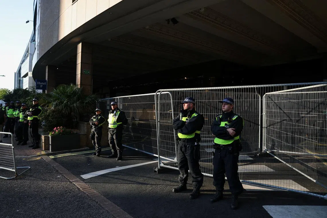 FILE PHOTO: Police officers stand guard in Canary Wharf, London, Britain, August 8, 2025. REUTERS/Hannah McKay/File Photo