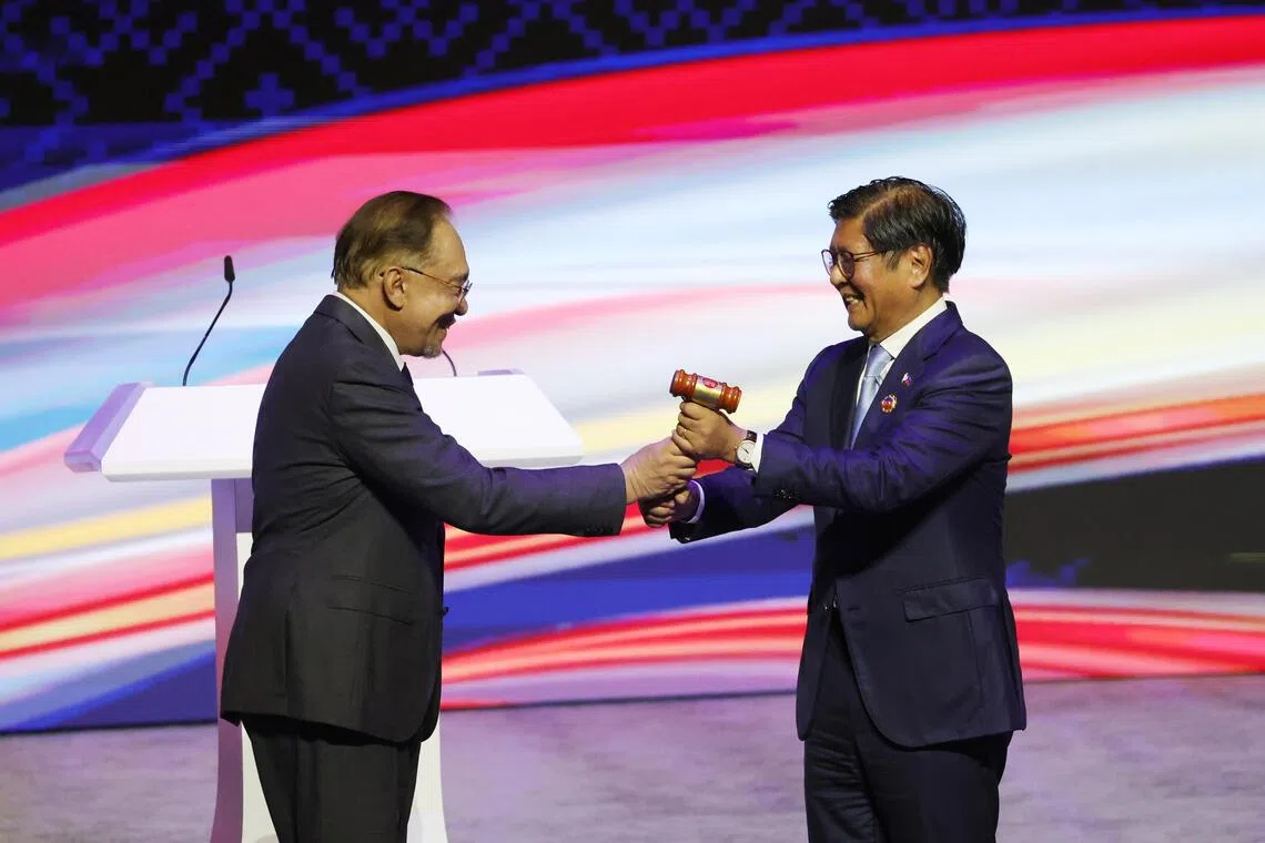 Malaysia's Prime Minister Anwar Ibrahim (left) passing the Asean chairmanship to Philippine President Ferdinand 'Bongbong' Marcos Jr.