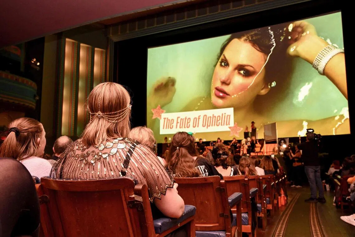 Taylor Swift fans listen to a song during a listening event for her new album The Life Of A Showgirl at the Astor Theatre in Melbourne on Oct 3.