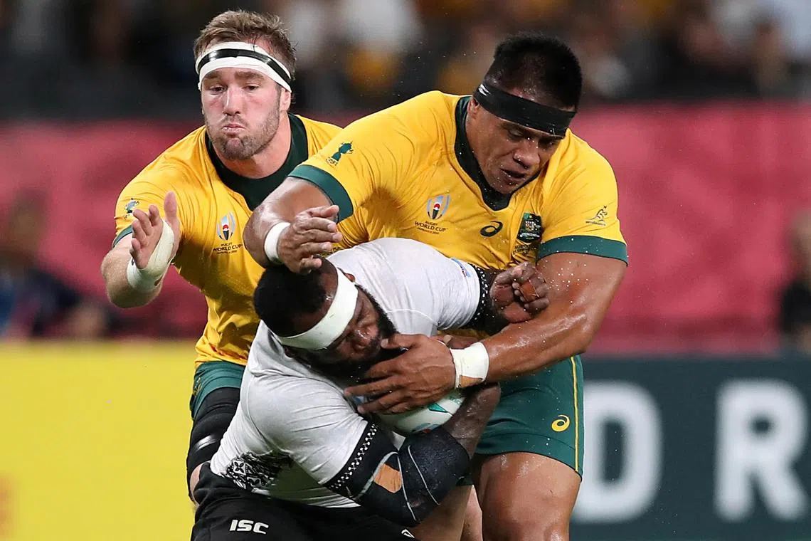 FILE PHOTO: Rugby Union - Rugby World Cup 2019 - Pool D - Australia v Fiji - Sapporo Dome, Sapporo, Japan - September 21, 2019 Fiji's Levani Botia in action with Australia's Allan Alaalatoa and Izack Rodda REUTERS/Peter Cziborra/File Photo