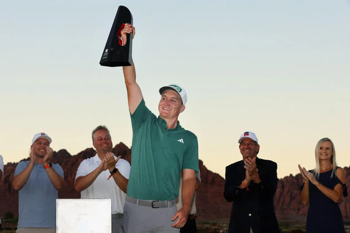 Matt McCarty of the United States celebrates with the trophy after winning the final round of the Black Desert Championship.