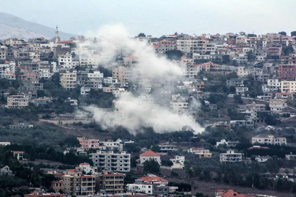 Smoke billows from the site of an Israeli strike that targeted the southern Lebanese village of Khiam on Sept 22.