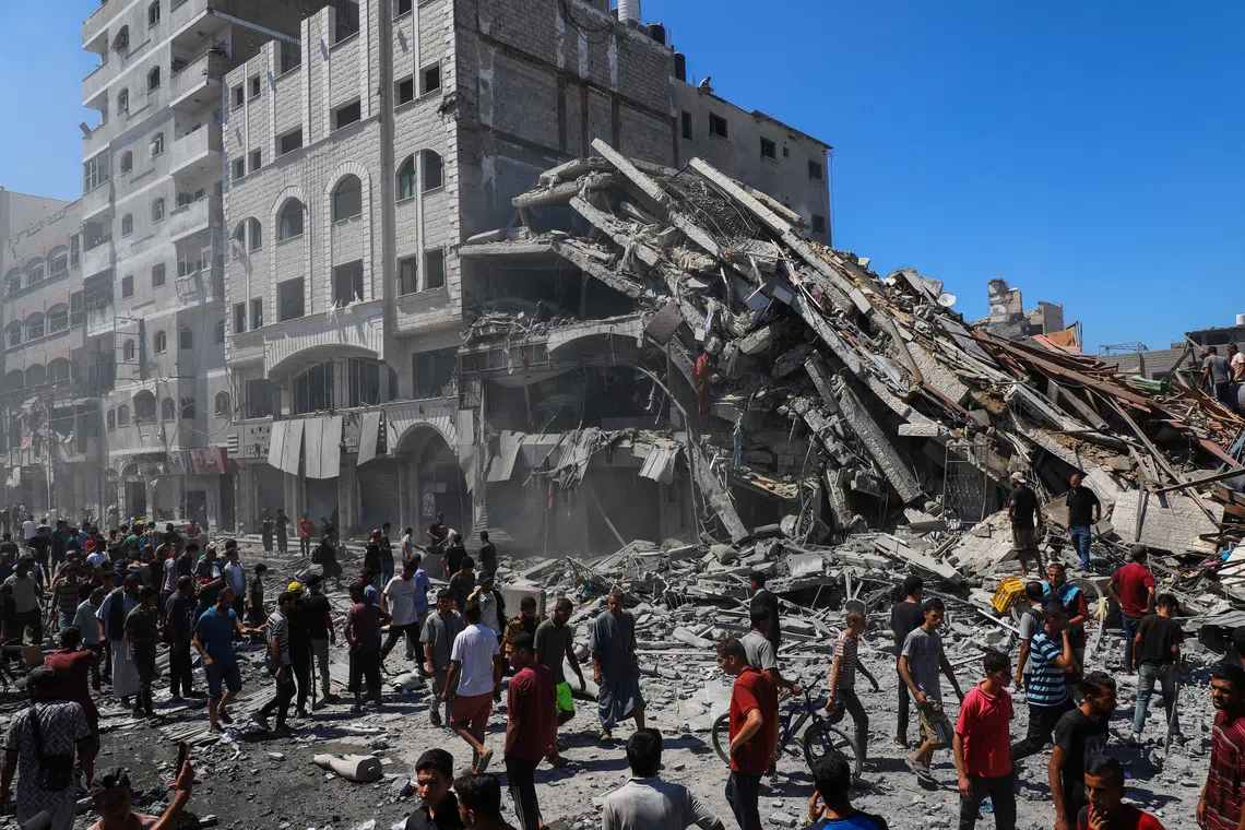Palestinians inspect the site of an evacuated house, after it was hit by an Israeli air strike, in Gaza City, September 12, 2025. REUTERS/Ebrahim Hajjaj