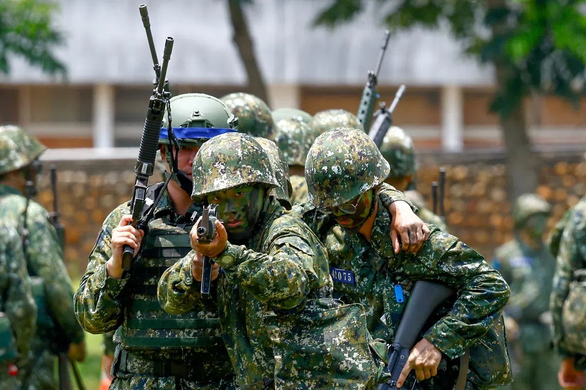 FILE PHOTO: A new military recruit aims a weapon during a training in Taichung, Taiwan June 28, 2024. REUTERS/Ann Wang/File Photo