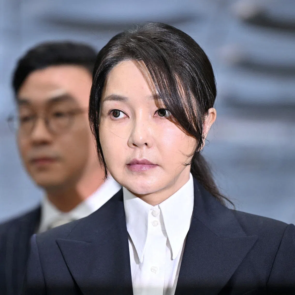 South Korea's former first lady Kim Keon Hee (centre) was sentenced to four years in prison for stock manipulation and bribery.