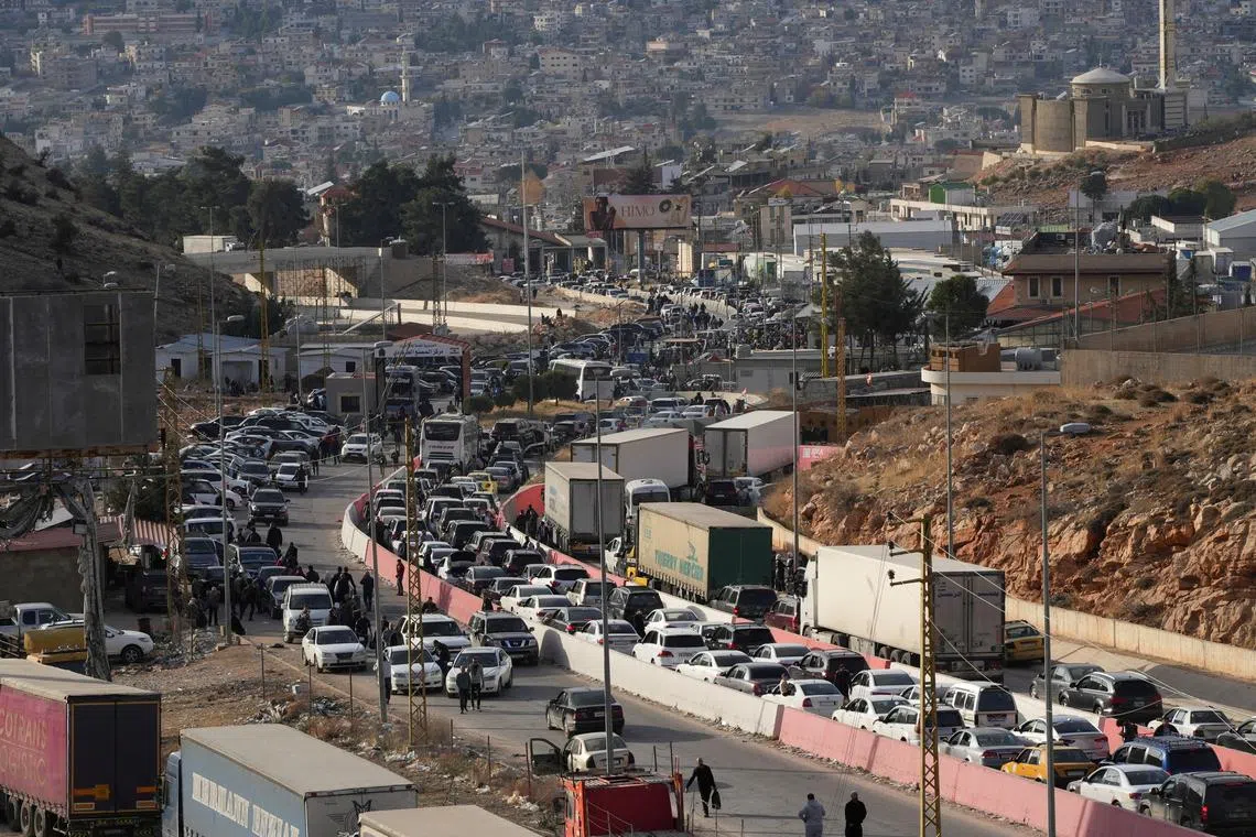 People make their way as they attempt to cross into Lebanon at the Masnaa border crossing between the Lebanon and Syria, after Syrian rebels announced that they have ousted Syria's Bashar al-Assad, as pictured from the Syrian side December 9, 2024. REUTERS/Mohammed Yassin/File Photo