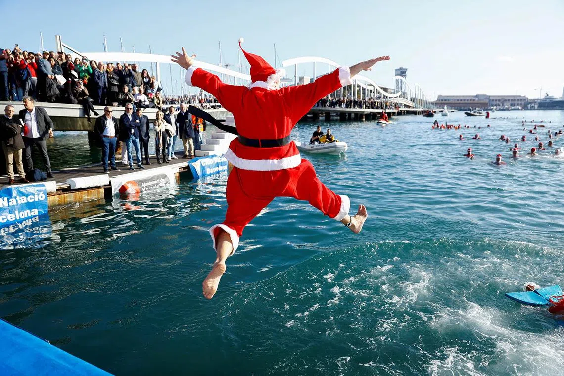 A person dressed as Santa Claus jumps into the sea during the Copa Nadal (Christmas Cup) swimming race in Barcelona, Spain December 25, 2024. REUTERS/Bruna Casas TPX IMAGES OF THE DAY