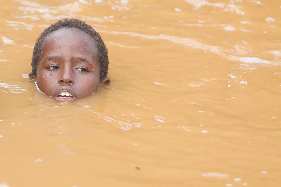 A Somali boy swims through flood water following heavy rains that have led the Juba river to overflow and flood large swathes of land in Dolow, Gedo region, Jubaland State of Somalia, November 12, 2023. REUTERS/Feisal Omar