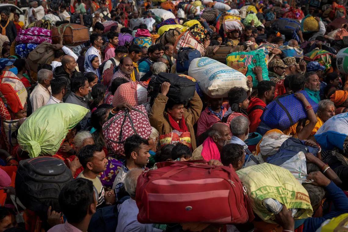 FILE PHOTO: Devotees wait to enter a railway station as they leave after attending the \"Maha Kumbh Mela\", or the Great Pitcher Festival, a day after a deadly stampede, in Prayagraj, India, January 30, 2025. REUTERS/Adnan Abidi/File Photo