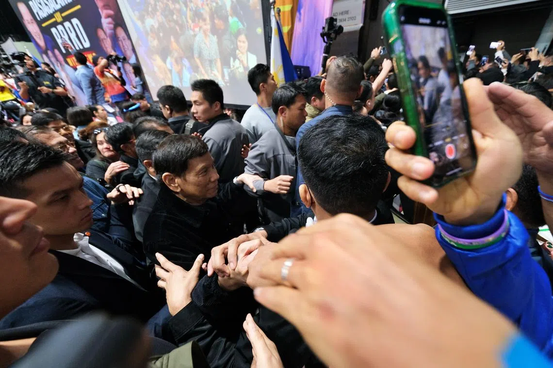 epa11952843 A handout photo made available by the Office of Vice-President Sara Duterte (OVP-SARA) shows former Philippine Rodrigo Duterte (C) shaking hands to his supporters during a gathering at a gymnasium in Hong Kong, China, 09 March 2025 (issued 10 March 2025). Duterte is in Hong Kong to lead a campaign sortie of his senatorial slate among overseas Filipino workers.  EPA-EFE/OVP- SARA / KING RODRIGUEZ / HANDOUT HANDOUT EDITORIAL USE ONLY/NO SALES