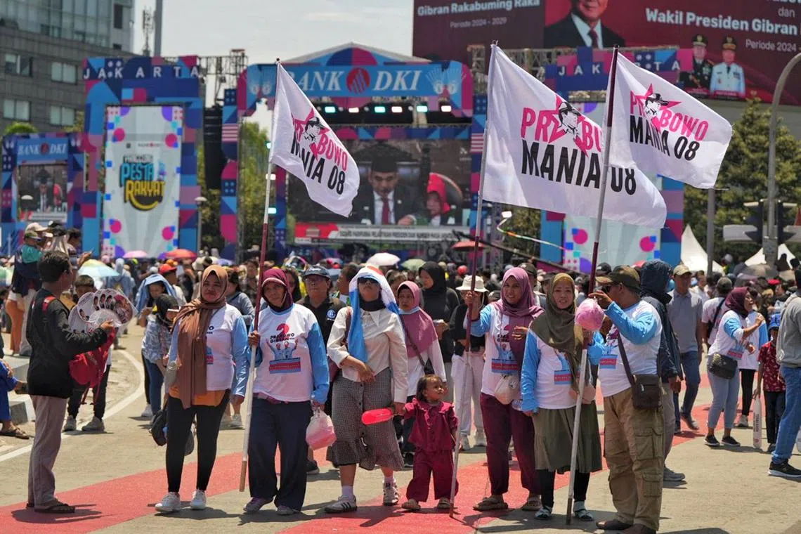 Supporters marching down the Bundaran HI roundabout in Jakarta to celebrate the inauguration of Indonesian President Prabowo Subianto and Vice-President Gibran Rakabuming Raka on Oct 20.