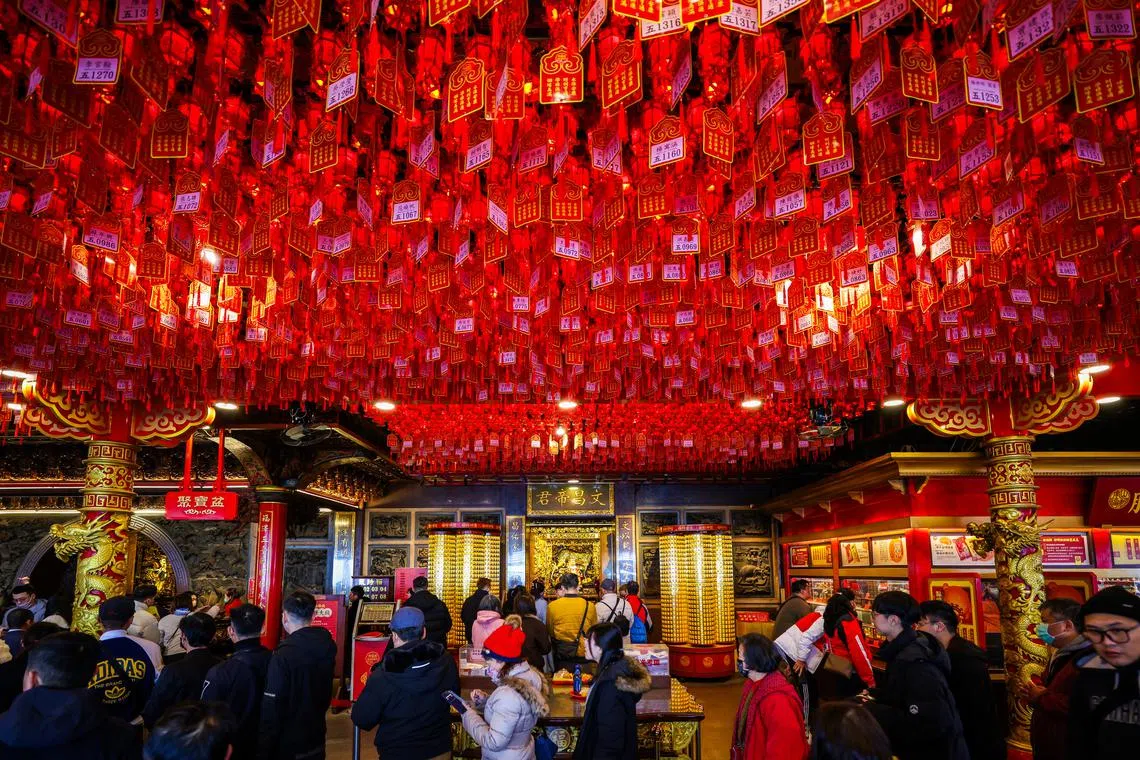 People queuing to pray inside a temple during the celebration of the Chinese Lunar New Year in Taipei, Taiwan, Feb 10, 2024. 