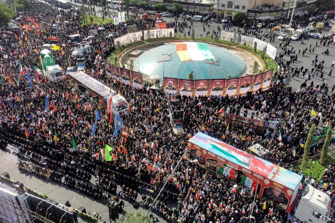 A funeral procession on June 28 for military commanders and scientists killed in Israeli strikes, with the images of those slain displayed around Enqelab Square in Tehran.