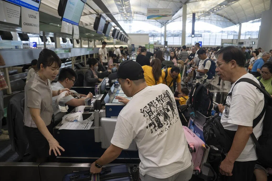 epa11487909 Airline employees manually check-in passengers at Hong Kong International Airport in Hong Kong, China, 19 July 2024. Airlines at Hong Kong airport have been hit and are being managed manually due to the systems being affected by a global tech IT outage. Companies and institutions around the world have been affected on 19 July by a major computer outage in systems running Microsoft Windows linked to a faulty CrowdStrike cyber-security software update. According to CrowdStrike's CEO, the issue has been identified, isolated and a fix has been deployed.  EPA-EFE/LEUNG MAN HEI