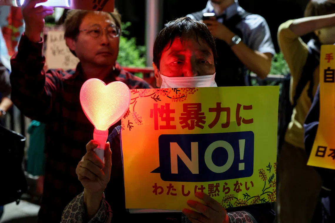A demonstrator holds a “no to sexual violence” placard in protest following the killing of a Japanese woman in Okinawa.