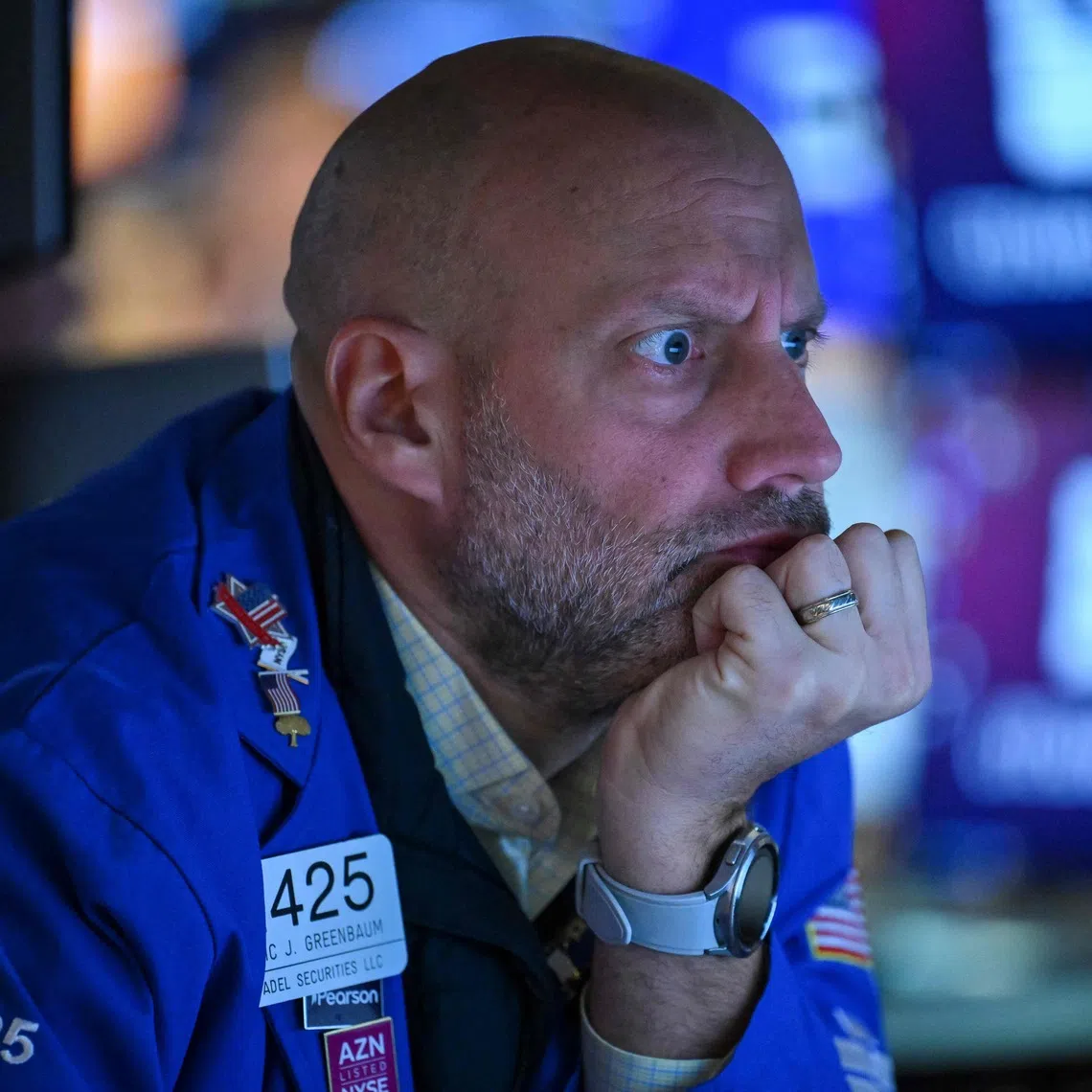 A trader works on the floor of the New York Stock Exchange at the opening bell in New York City on Oct 19.