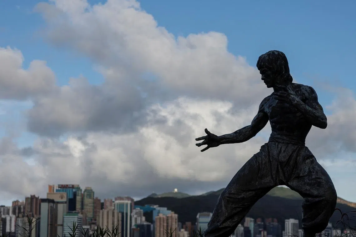 A statue of the martial artist and actor Bruce Lee is silhouetted against the skyline on the Avenue of Stars attraction near the Tsim Sha Tsui waterfront, in Hong Kong, China June 28.