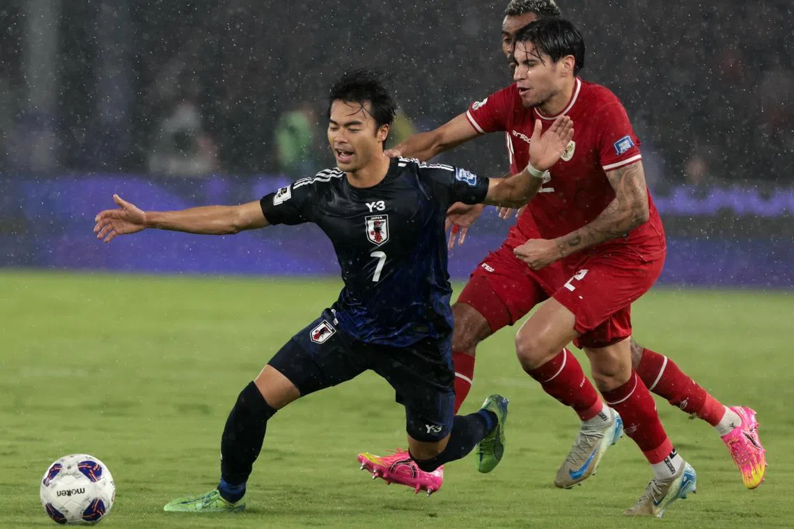 Kaoru Mitoma of Japan battling Kevin Diks of Indonesia during their World Cup qualifier.