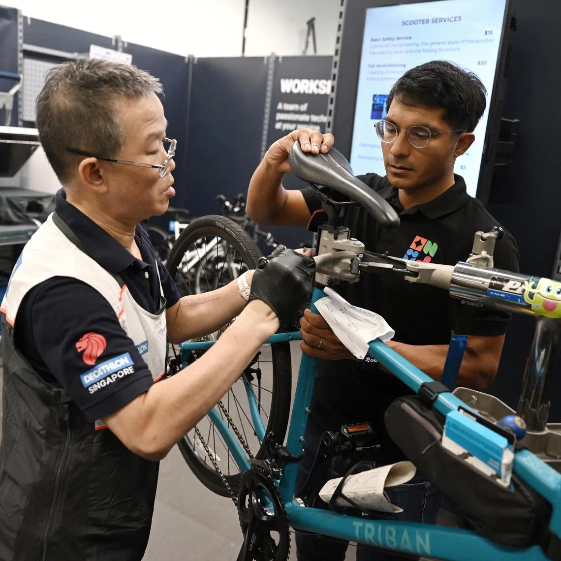 ST20240320_202402891036/radecath /Roselind Ang/ Azmi Athni//

Profile of Mr Nathaniel Gregory (right), Circular Economy & Services Lead of Decathlon Singapore, services a bicycle with Decathlon’s bike technician Mr Jin Ngee during the launch of the Official Decathlon Carousell Store on Mar 20. 

ST PHOTO: AZMI ATHNI