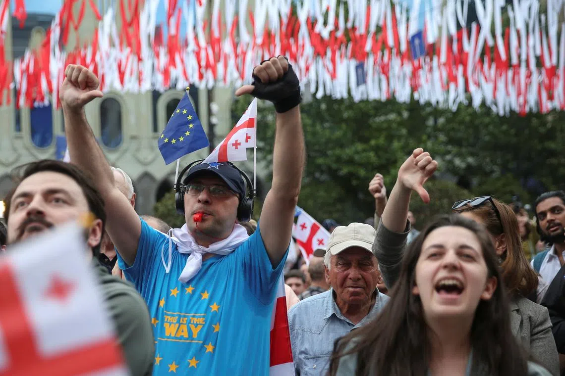 Demonstrators hold a rally to protest against a bill on \"foreign agents\", after Georgia's parliament voted to override a presidential veto of the bill, in Tbilisi, Georgia, May 28, 2024. REUTERS/Irakli Gedenidze