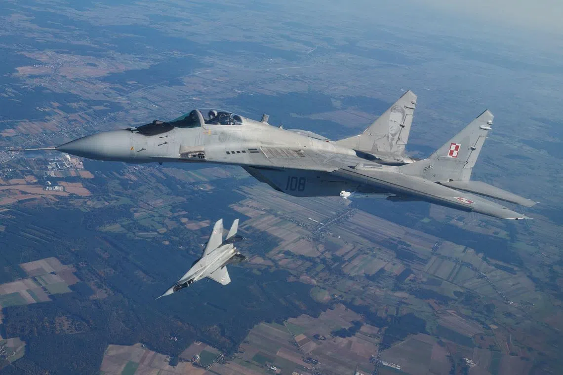 A file photo taken on Oct 12, 2022 shows two MiG 29 fighter jets taking part in the NATO Air Shielding exercise near the air base in Lask, central Poland.