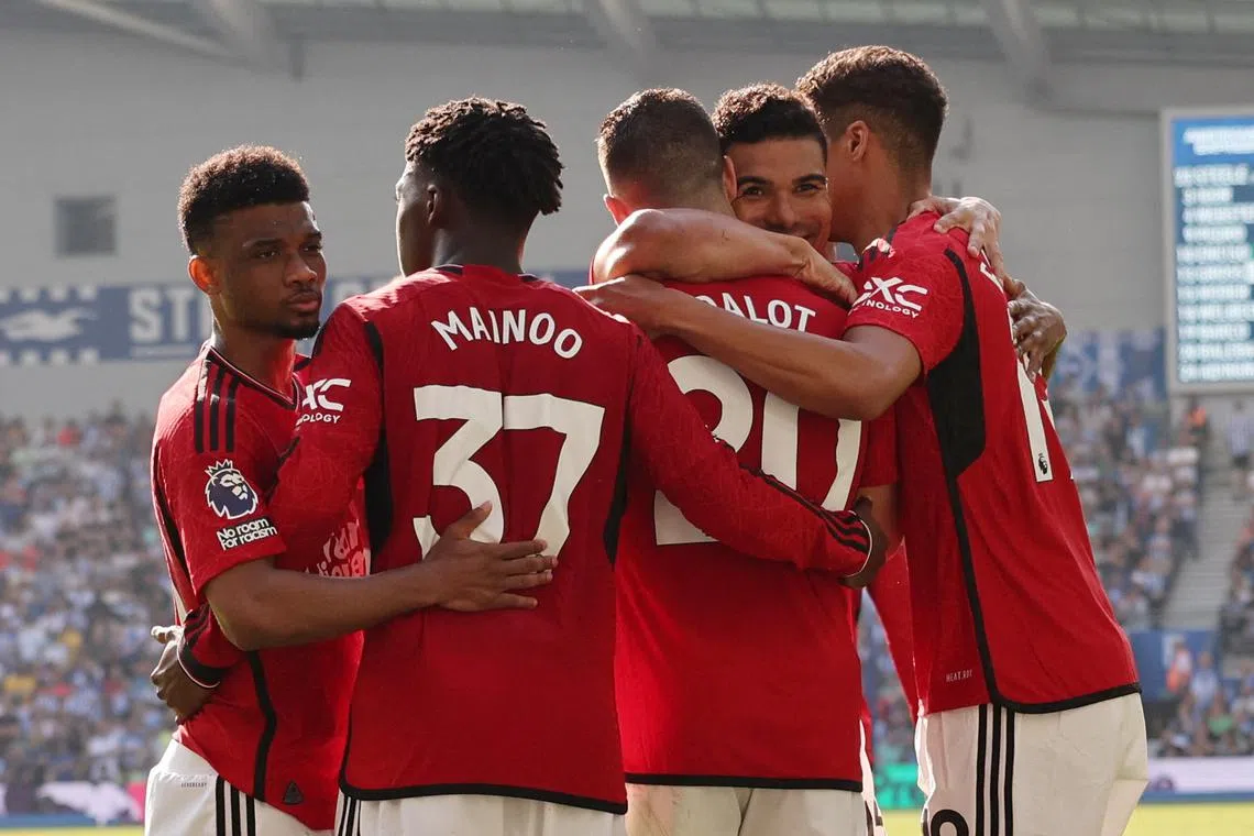 Soccer Football - Premier League - Brighton & Hove Albion v Manchester United - The American Express Community Stadium, Brighton, Britain - May 19, 2024  Manchester United's Diogo Dalot celebrates scoring their first goal with teammates REUTERS/David Klein